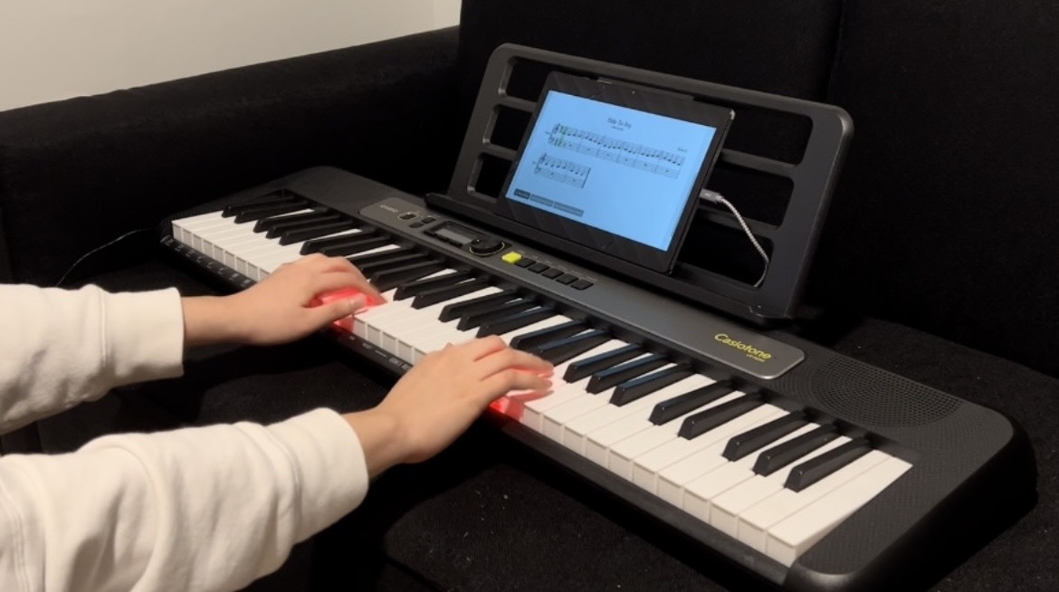 Learning Piano Songs with Passive Haptic Training: an Interactive Lesson